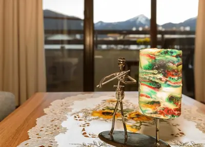a pair of figurines sitting on a table with a bottle at Niki's cosy place in Bansko