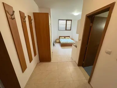 a hallway with a room with a bed in it at Basment Rooms - Todorini Kuli in Bansko