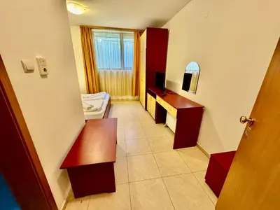 a room with a desk and a sink and a mirror at Basment Rooms - Todorini Kuli in Bansko