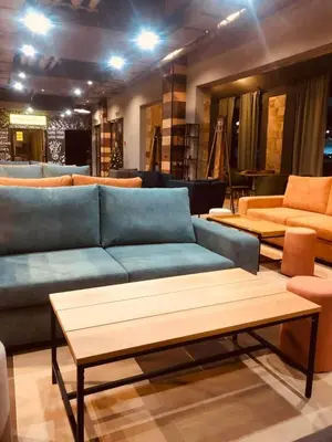 a living room with a blue couch and tables at Luxuriously furnished and cozy studio - Magnolia in Borovets