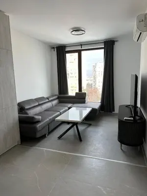 a living room with a couch and a table at Lovely Stylish Brand New Flat in Sofia