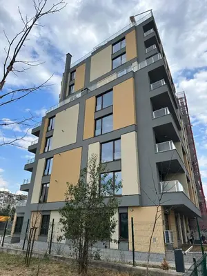 a tall apartment building with a fence in front of it at Lovely Stylish Brand New Flat in Sofia