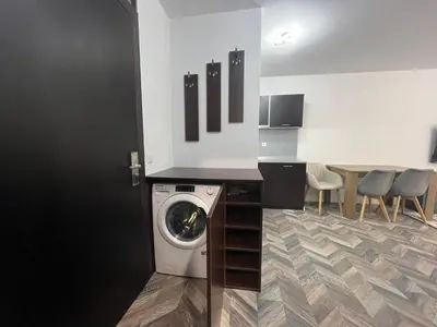 a laundry room with a washing machine and a table at Ski cosy apartment 5 in Bansko
