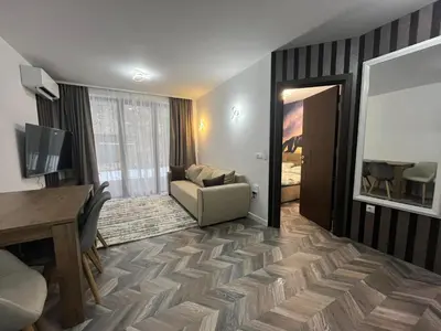 a living room with a couch and a table at Ski cosy apartment 5 in Bansko
