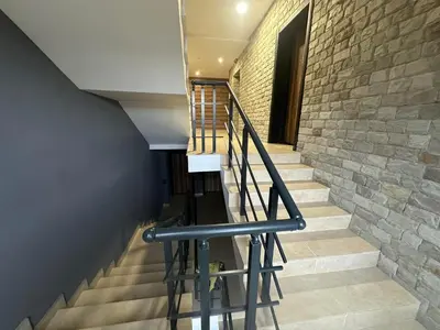 a staircase in a building with a stone wall at Апартамент Гончеви in Velingrad