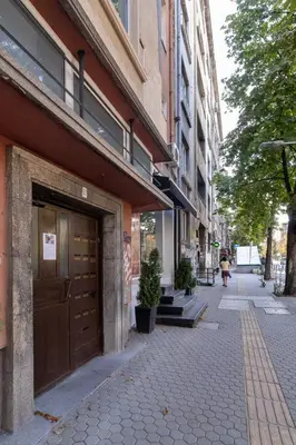 a building with a door on the side of a street at Brand new Apartments in Sofia Center, Steps to Metro, NDK, Vitosha boulevard in Sofia