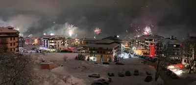 a city lit up with fireworks in the snow at Banskodom in Bansko