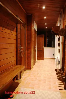 a room with a sauna with wooden walls and benches at Banskodom in Bansko
