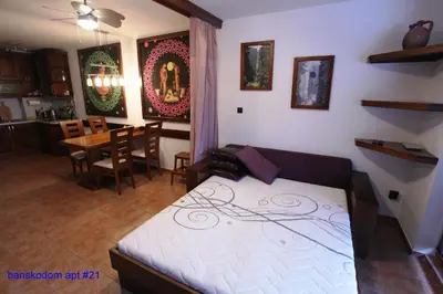 a bedroom with a bed and a dining room at Banskodom in Bansko