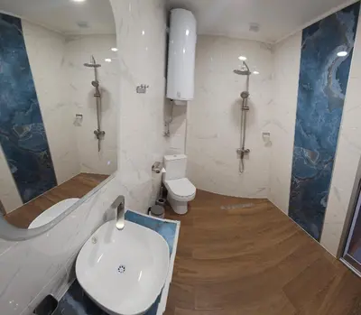 a bathroom with a white sink and a toilet at Къща за гости ЕСТЕТ ESTET Guest house in Oreshak
