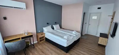 a bedroom with a bed and a desk and a bed sidx sidx sidx at Къща за гости ЕСТЕТ ESTET Guest house in Oreshak
