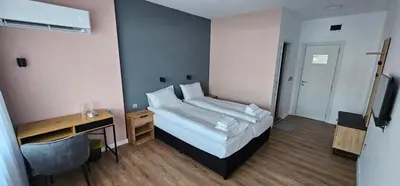 a hotel room with a bed and a desk and a computer at Къща за гости ЕСТЕТ ESTET Guest house in Oreshak