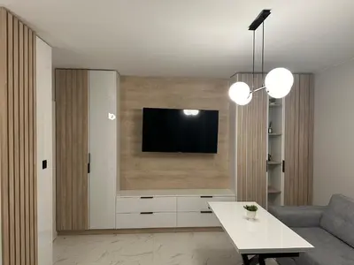 a living room with a tv on a wall at Cherry in Sofia