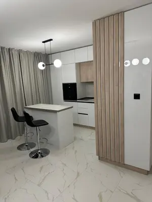 a kitchen with a desk and a chair in a room at Cherry in Sofia
