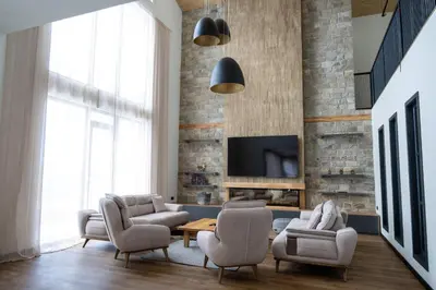 a living room with two chairs and a tv at Chalet Pamporovo in Pamporovo