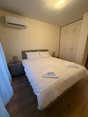 a bedroom with a bed with two towels on it at PanOrama Luxury Apartments in Panagyurishte