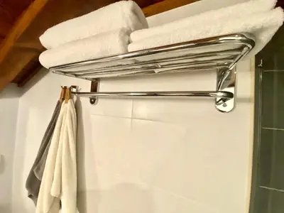 a towel rack in a bathroom with towels at Host2U Penthouse 2-Bedrooms The Best View - Free Parking in Bansko