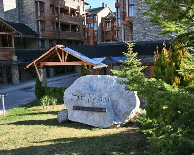 a sign on a rock in front of a building at Host2U Penthouse 2-Bedrooms The Best View - Free Parking in Bansko