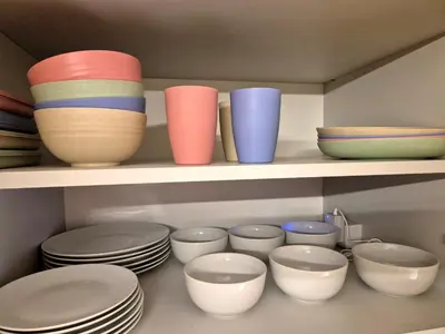 a bunch of bowls and plates on a shelf at The VERTEX in Sofia