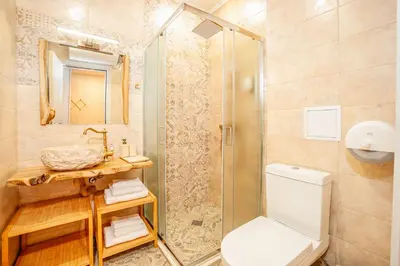 a bathroom with a shower and a toilet and a sink at Golden Lake 526 at Oak Residence in Smolyan