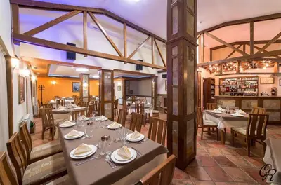 a restaurant with tables and chairs in a room at Golden Lake 526 at Oak Residence in Smolyan