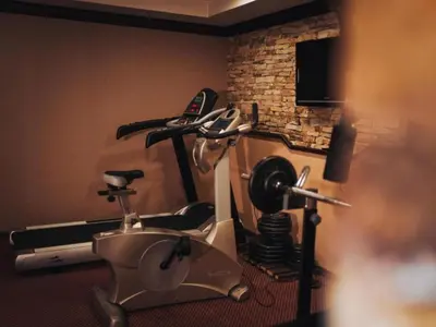 a room with a gym with a exercise bike at Snowflake- Luxury stay with a Bottle of Wine,free Parking and SPA in Royal Park in Bansko