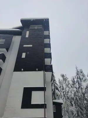 a tall building with the letter l on it at Forest Chamkoria Apartment in Borovets