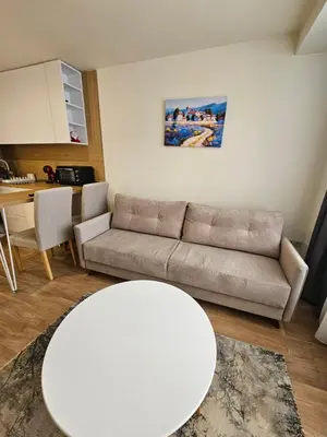 a living room with a couch and a table at Forest Chamkoria Apartment in Borovets