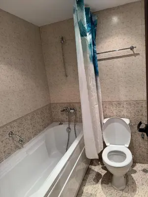 a bathroom with a toilet and a bath tub with a toilet at Emerald Apartment - complex Bansko in Bansko