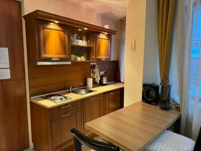 a small kitchen with a sink and a table at Emerald Apartment - complex Bansko in Bansko