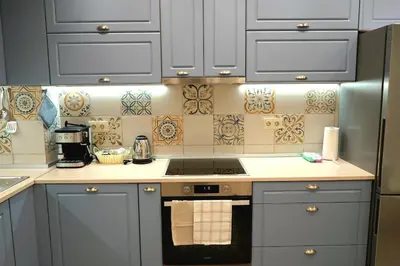 a kitchen with gray cabinets and a stove top oven at Cozy Apartment in the Heart of Sofia, BG in Sofia