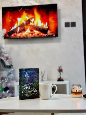 a book sitting on a table next to a coffee cup at Pirin Cozy Escape 8 min walk from ski lift - Private Apartment Grand Bansko 1 in Bansko