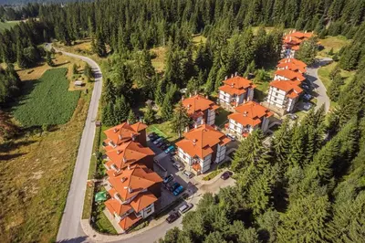 an aerial view of a large house with orange roofs at ЕлеаНора, Смолянски езера EleaNora Smolyan lakes in Smolyan