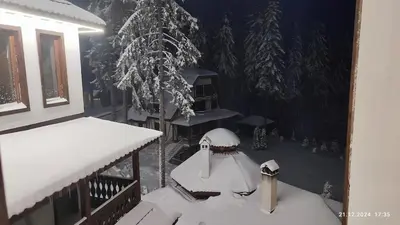 a balcony covered in snow with a table and trees at Grand Studio B27 in Pamporovo