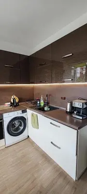 a kitchen with a stove and a washing machine at Spacious, Comfortable Top Central Apartment in Sofia
