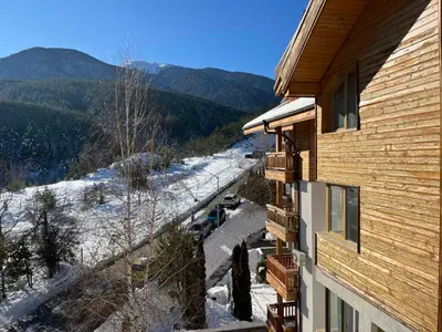 a view of a snow covered road next to a house at Daliya's Apartment in Bansko