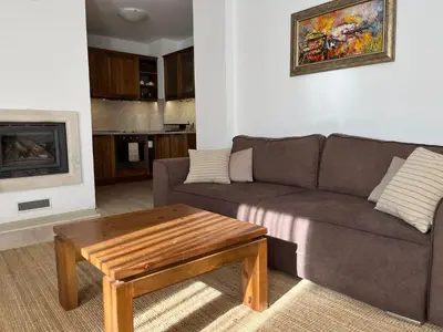 a living room with a couch and a coffee table at Daliya's Apartment in Bansko