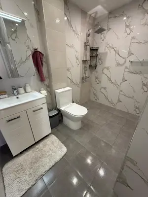 a bathroom with a toilet and a sink at Delux 2 - Plovdiv Модерен апартамент до Стария град и Източната порта in Plovdiv