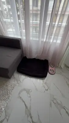 a living room with a couch and a window at Delux 2 - Plovdiv Модерен апартамент до Стария град и Източната порта in Plovdiv