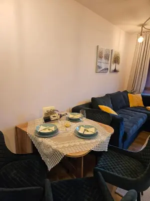 a living room with a table and a couch at ELIA Apartment in Bansko