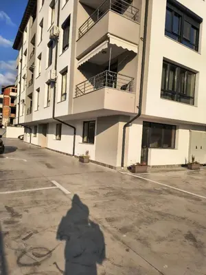 a shadow of a person standing in front of a building at Infinity Park Apartment in Sandanski