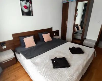 a bedroom with a bed with two black hats on it at Belvedere Holiday Club F403 in Bansko