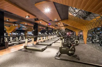 a gym with rows of exercise bikes and treadmills at Capital City Center Apart Residence in Plovdiv