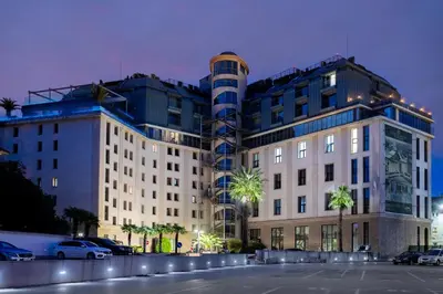 a building with a parking lot in front of it at Capital City Center Apart Residence in Plovdiv