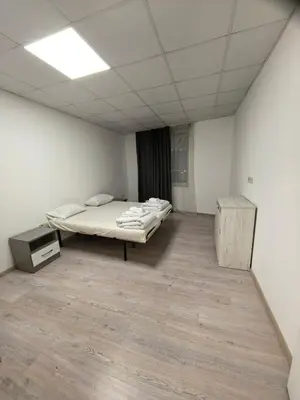 a room with a bed and a desk in it at Apartament Bellisimo in Sofia