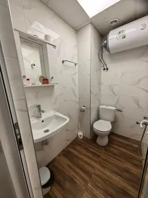 a bathroom with a toilet and a sink at Apartament Bellisimo in Sofia