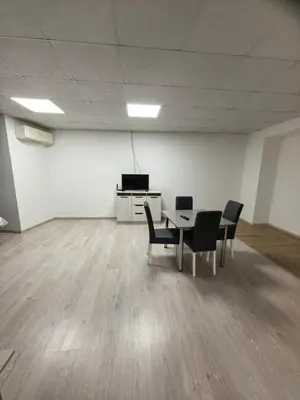 a room with a table and chairs and a television at Apartament Bellisimo in Sofia
