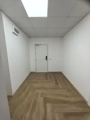 an empty room with a door and a wooden floor at Apartament Bellisimo in Sofia