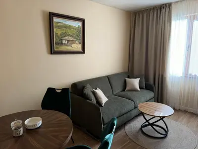 a living room with a couch and a table at Guest Apartment Elina in Smolyan