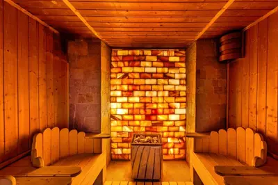 an empty sauna with two chairs and a fireplace at Sun and view cozy apartment in Razlog